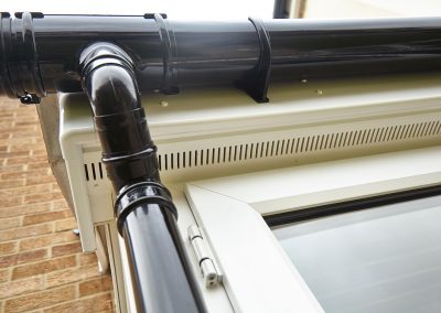 black guttering and white fascias and soffits on upvc porch