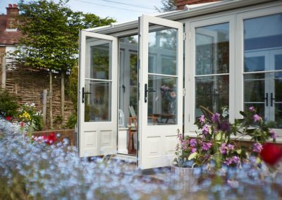 french doors opening on to garden from pebble grey timber conservatory Hutchings4245