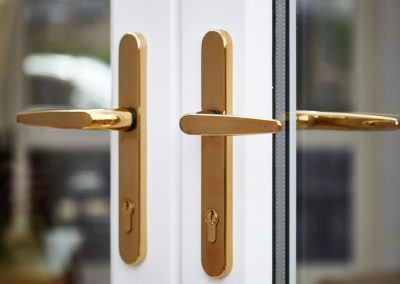 gold handles on white woodgrain upvc french doors Whittaker2823