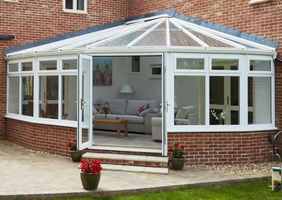 victorian upvc conservatory in white woodgrain with french doors Whittaker2789