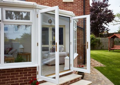 victorian upvc conservatory in white woodgrain with french doors Whittaker2858